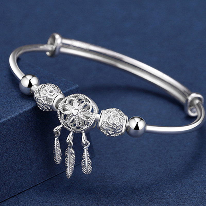 Dream Catcher Blessing Bracelet – Silver bangle with filigree dreamcatcher and feather dangles on navy, boho silver
