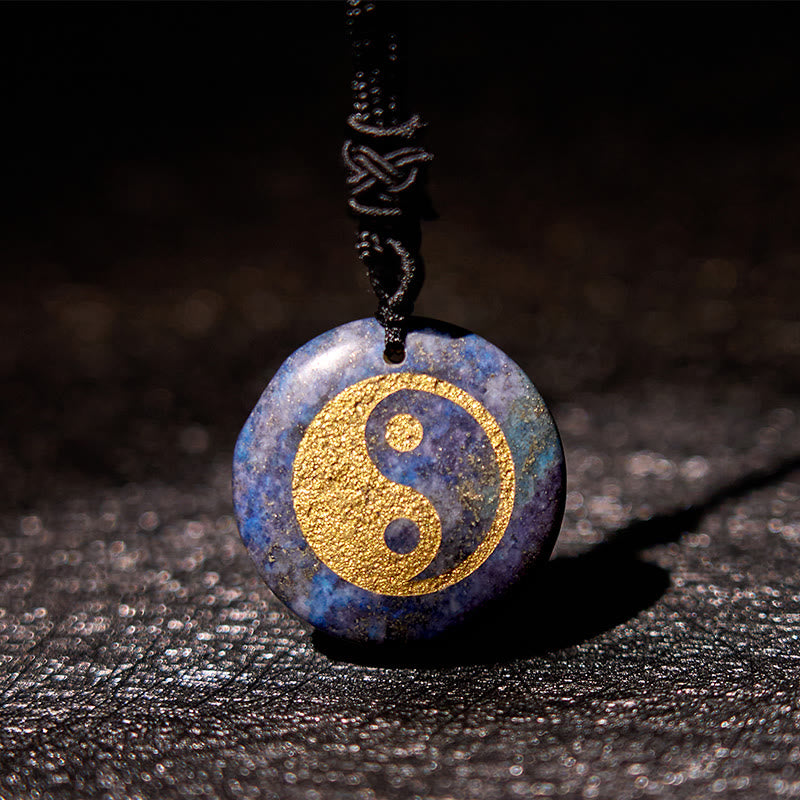 Yin Yang Crystal Necklace – Lapis lazuli pendant with gold yin-yang symbol, deep blue stone with golden mineral inclusions on