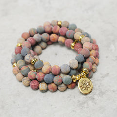 Picasso Jasper 108 Mala Bracelet - triple wrap spiral on stone surface, beaded bracelet