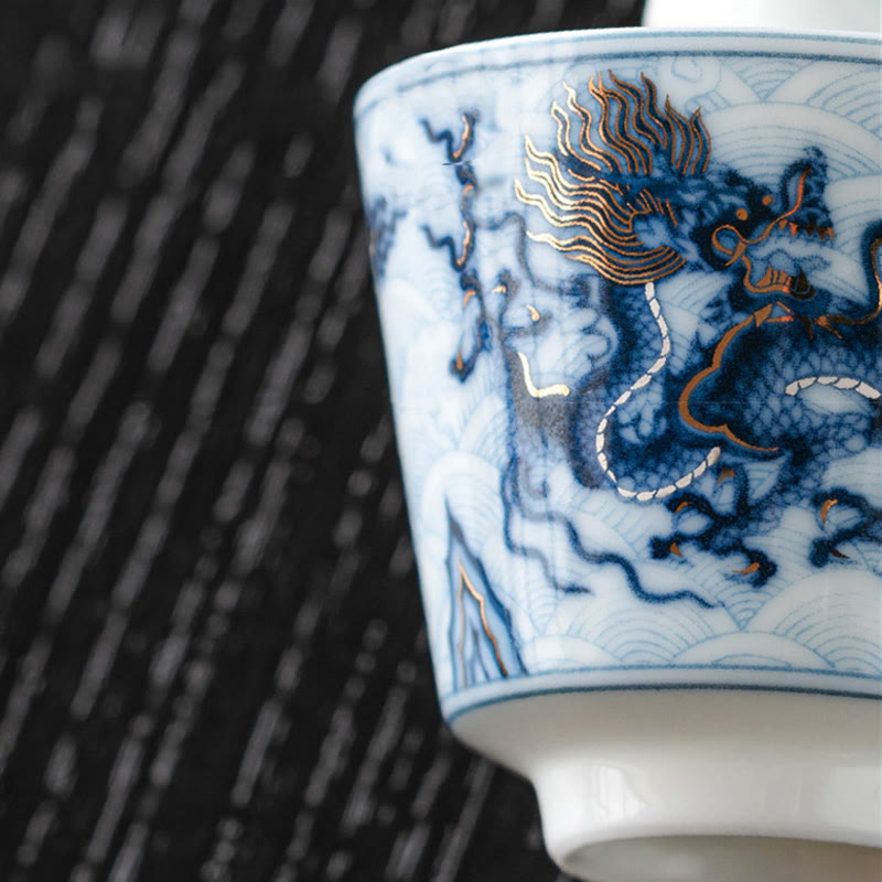 Blue & White Dragon Ceramic Teacup – close-up dragon on dark woven mat, blue white qinghua, luxury