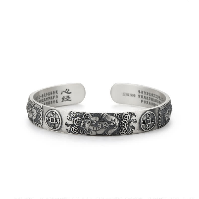 Sterling silver Pixiu bracelet on white background with mythical wealth beast, Zhao Cai Jin Bao coins, Heart Sutra engraving and 999 silver mark