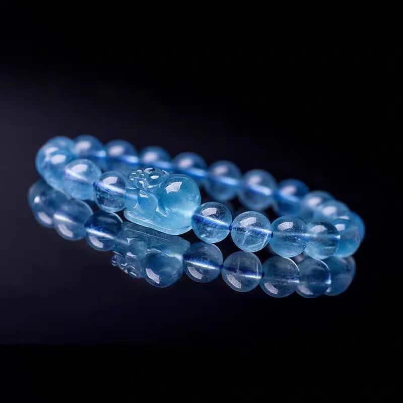 Natural Aquamarine PiXiu Serenity Bracelet – Aquamarine bracelet with carved PiXiu on reflective black surface, serenity