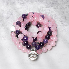 Rose Quartz Amethyst Healing Bracelet – coiled mala with lotus charm on marble surface, flatlay