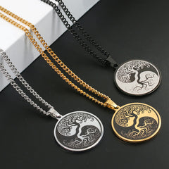 Tree of Life Titanium Steel Necklace – three pendants on black surface with white block, diagonal, connection pendant