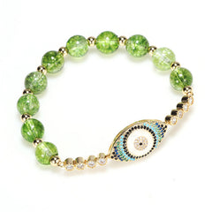 Peridot green crackle glass bracelet with gold evil eye charm and crystal accents