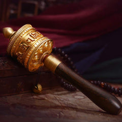 Copper Meditation Prayer Wheel – Gold brass drum with wood handle on weathered wood, zen decor