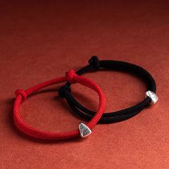 925 Silver Fu Character Braided Bracelet – Red braided cord with silver triangular fortune charm on matching textured red surface, overhead flat lay product shot