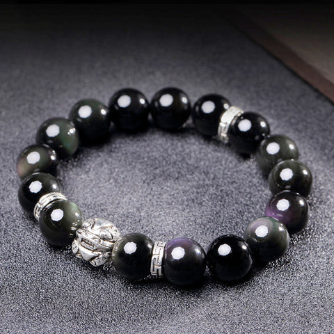 Rainbow Obsidian Bracelet – Silver PiXiu on textured gray surface, iridescent black beads, blessing Main image