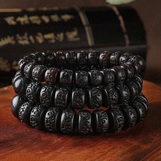 Lightning Strike Wood Bracelet – Three stacked black wood bead bracelets with Tibetan carvings, prayer bead set