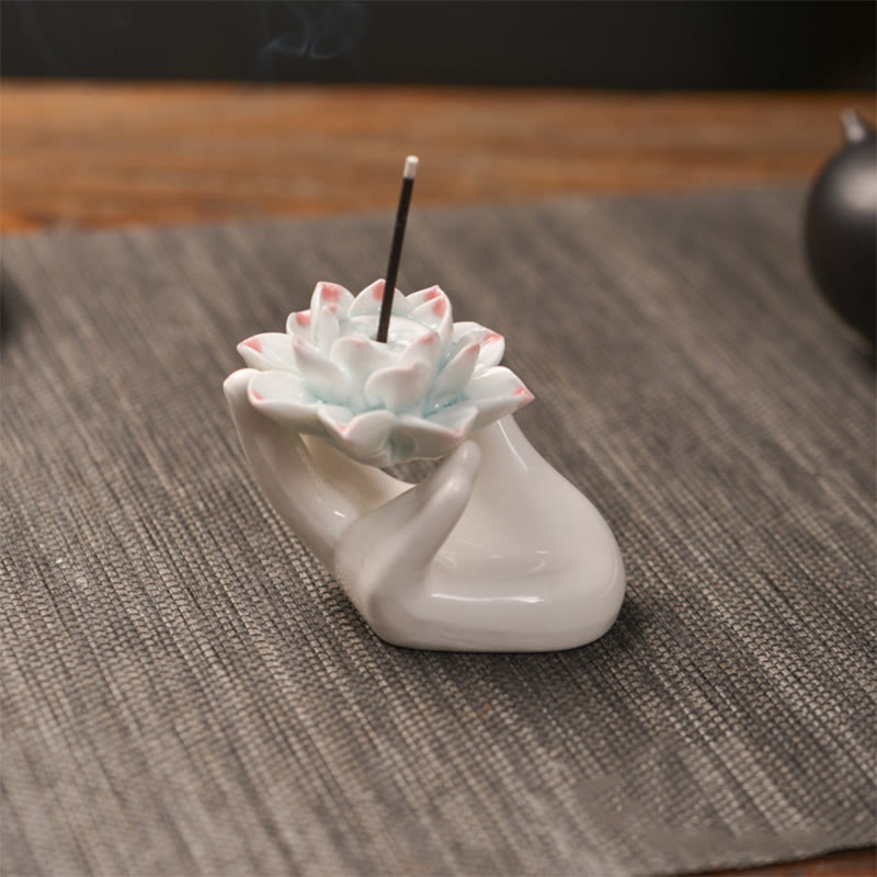 Ceramic Lotus Hand Incense Burner - hand cradling pink-tipped lotus with rising smoke, zen healing