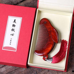 Red sandalwood bunny comb displayed in elegant red gift box with Chinese calligraphy