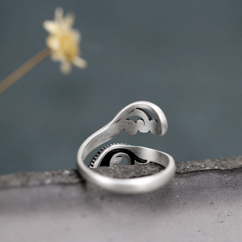 925 Sterling Silver Koi Ring – lifestyle shot on hand over dark fabric, polished silver koi and wave motif ring
