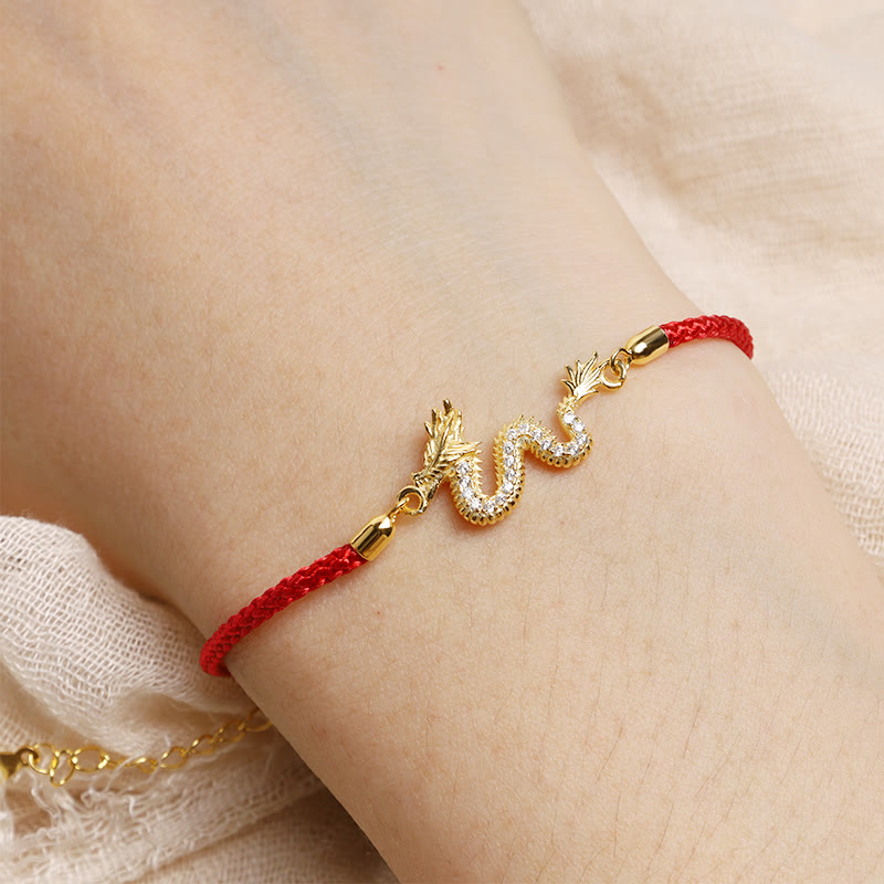 925 Silver Dragon Bracelet - Red cord dragon worn on wrist against soft cream, meaningful adornment