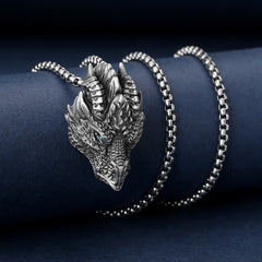 Pure Tin Dragon Head Necklace - Frontal dragon face with green stone eye on blue velvet, powerful luck