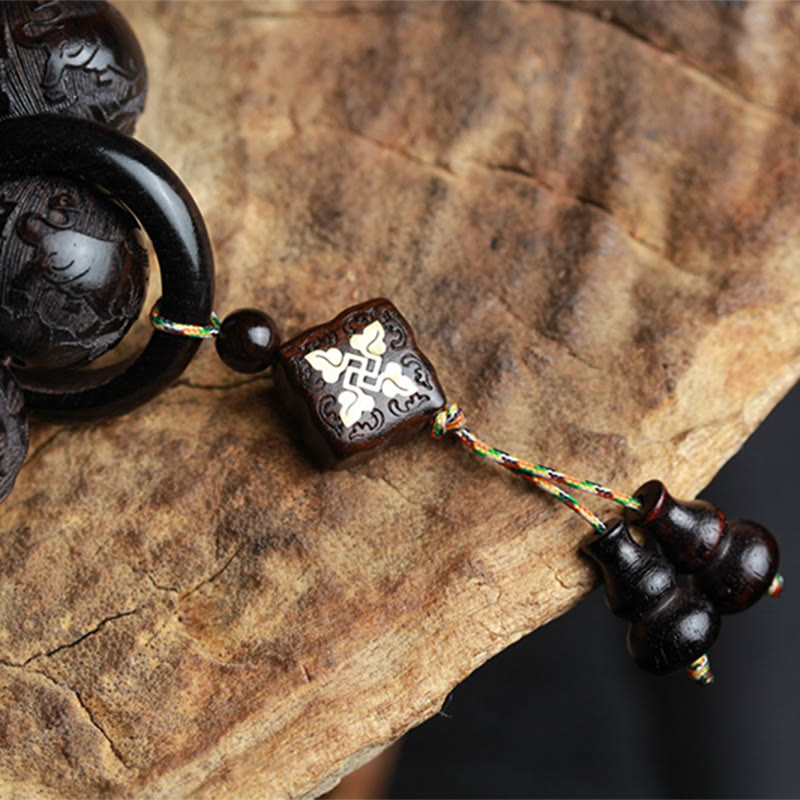 Ebony Wood Yin Yang Gourd Balance Bracelet - pendant detail with swastika inlay and double gourd charm on wood slice, carved wood talisman
