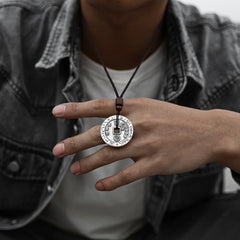 Bagua Yin Yang Obsidian Necklace - hand holding engraved coin with square hole, worn detail shot