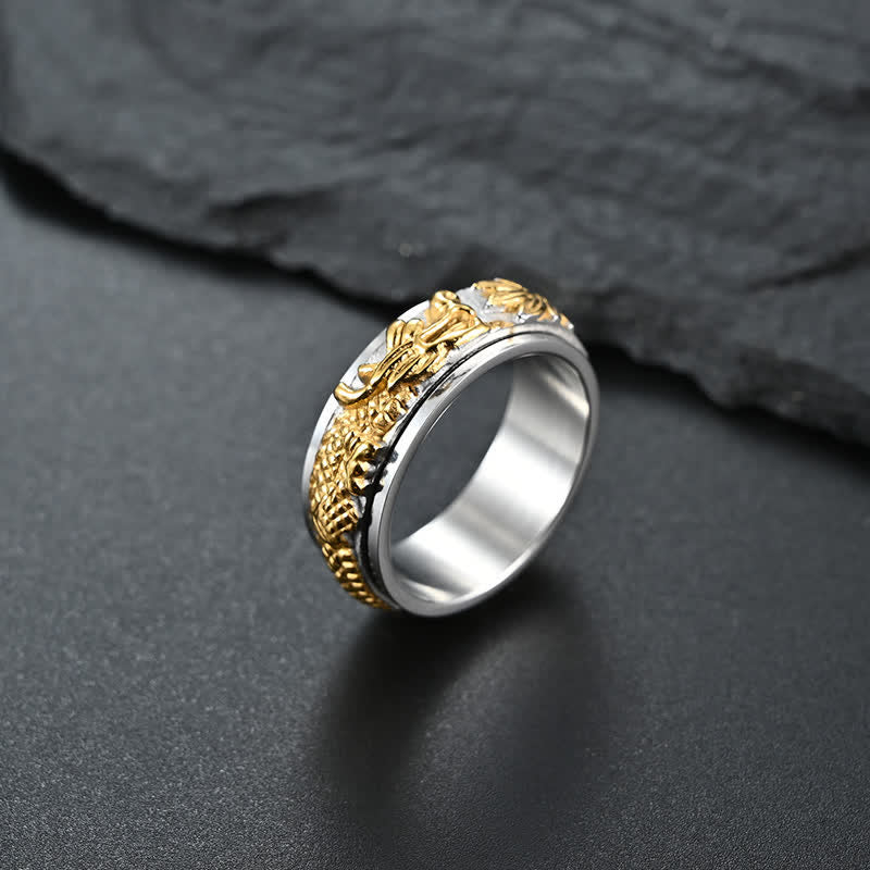 Dragon Titanium Steel Ring – Silver-gold dragon spinner on dark surface, balance