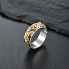 Dragon Titanium Steel Ring – Silver-gold dragon spinner on dark surface, balance