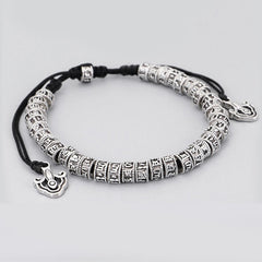 Tibetan Mantra Purity Bracelet – Antiqued silver cylindrical beads with Tibetan script on cord, mantra jewelry