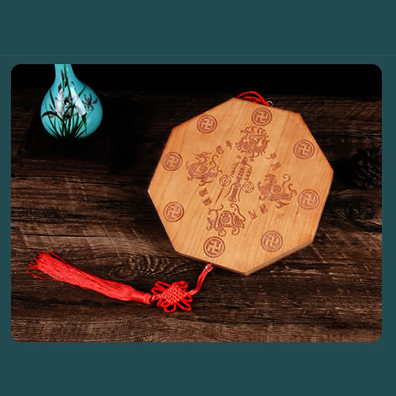 Peach Wood Bagua Map - octagonal bagua mirror with carved trigrams and red silk tassel on dark wood