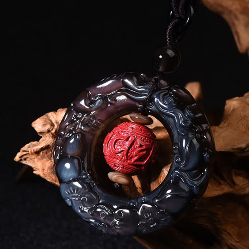 Rainbow Obsidian PiXiu Pendant – Carved rainbow obsidian pendant with red cinnabar on driftwood