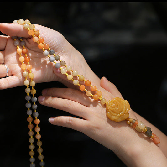 Golden Silk Jade Flower Pendant Necklace – warm gradient beads with honey-amber rose carved pendant, draped across hands