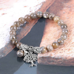 Tree of Life labradorite bracelet with gray iridescent flash beads, antique silver tree of life pendant with detailed branch design.