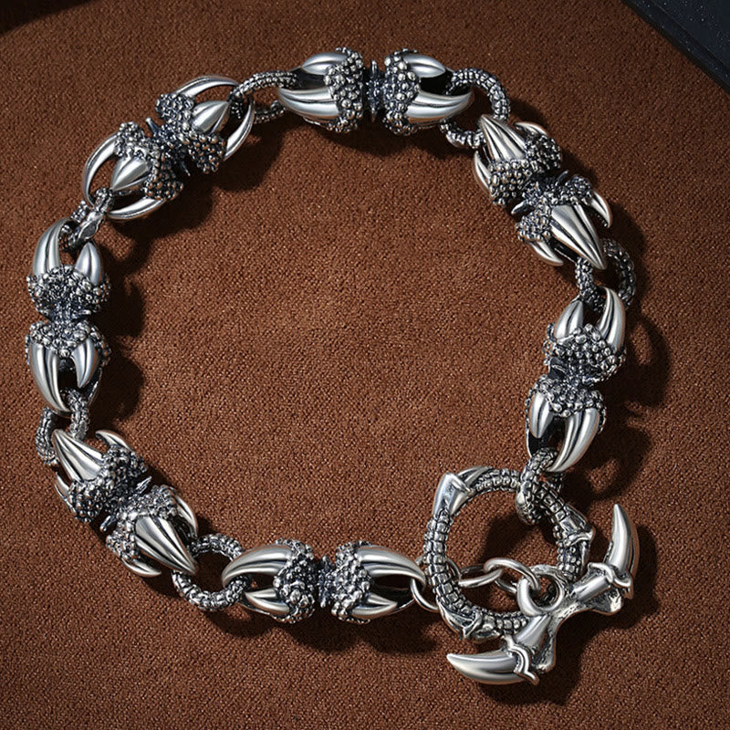 Dragon Claw Engraved Strength Protection Bracelet – Flat-lay overhead view, silver claw links, toggle clasp detail, Masculine