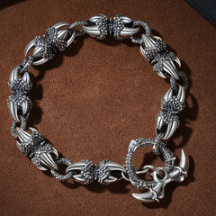 Dragon Claw Engraved Strength Protection Bracelet – Flat-lay overhead view, silver claw links, toggle clasp detail, Masculine
