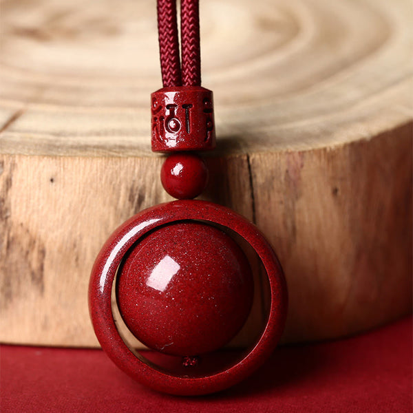 Cinnabar PiXiu Necklace – Close-up by wood slice showing Om Mani Padme Hum carving detail, luck charm