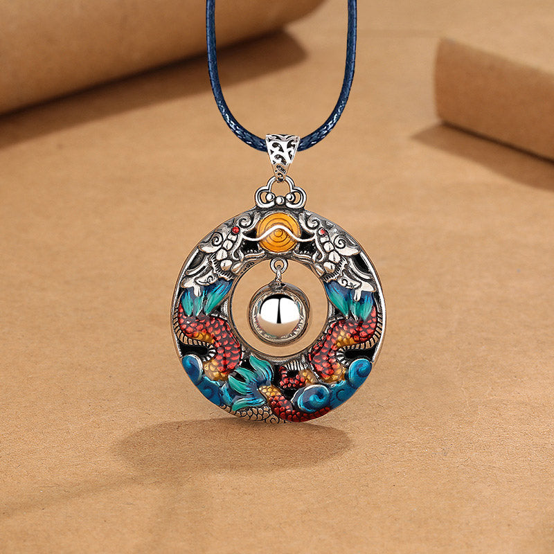 Double Dragon Copper Necklace – Dragon enamel pendant on navy blue braided cord, spinning silver bell center