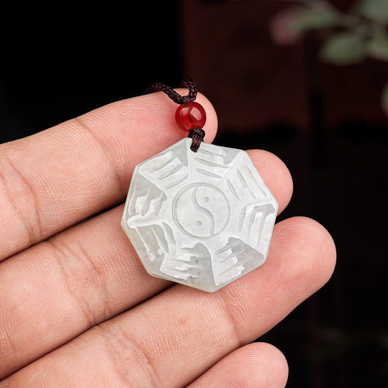 Natural Jade Bagua Yin Yang Luck Necklace - Hand holding octagonal jade bagua pendant with red bead, natural stone amulet