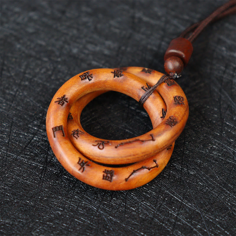 Qiankun Circle Necklace – Interlocking amber wood ring pendant with engraved Chinese characters and constellation symbols, to