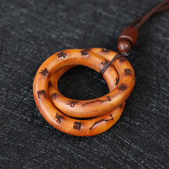 Qiankun Circle Necklace – Interlocking amber wood ring pendant with engraved Chinese characters and constellation symbols, to