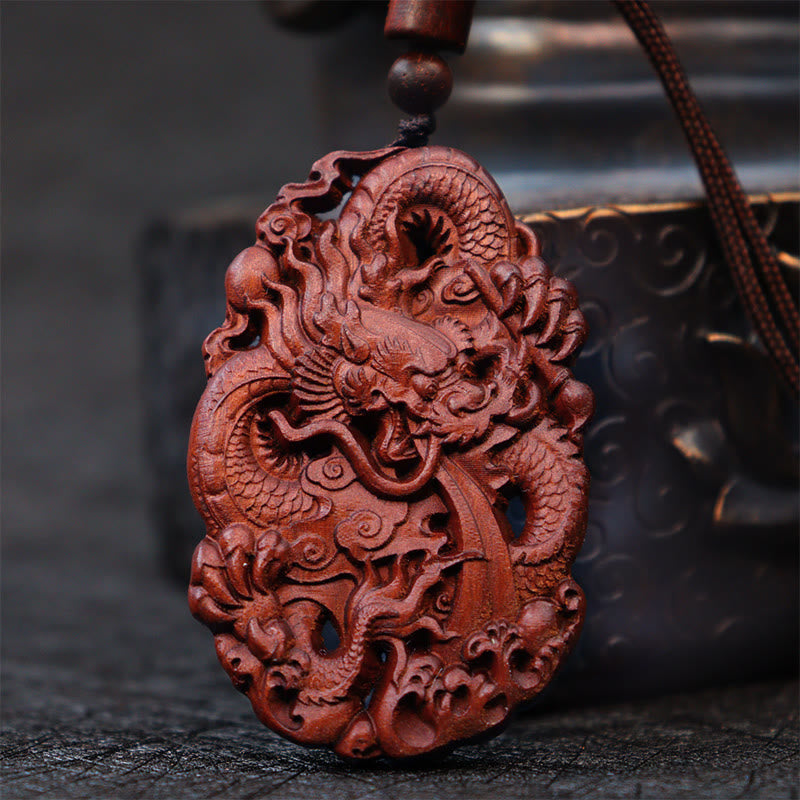 Lightning Jujube Wood Dragon Pendant - 3/4 view of carved dragon in clouds and waves, Protection