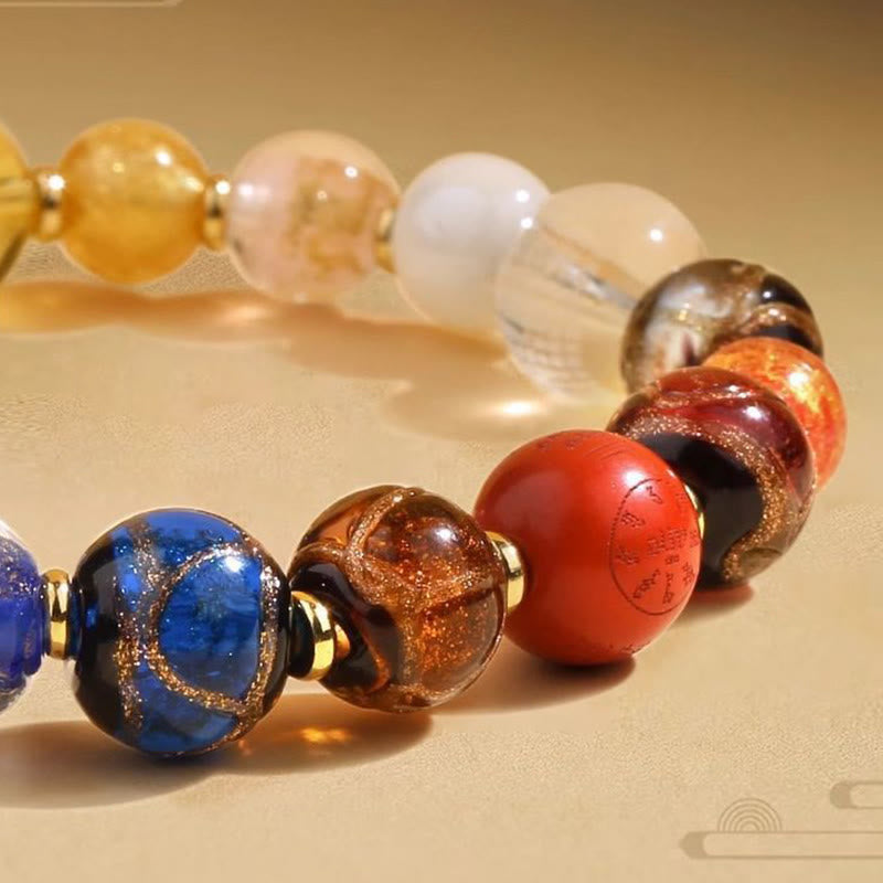 Tibetan Liuli Wrist Mala – Macro close-up of lapis and amber beads with gold spacers, mantra engravings