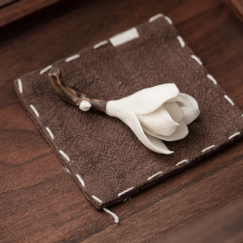 Gardenia Ceramic Incense Burner – White flower on hand-stitched brown cushion, dark wood backdrop