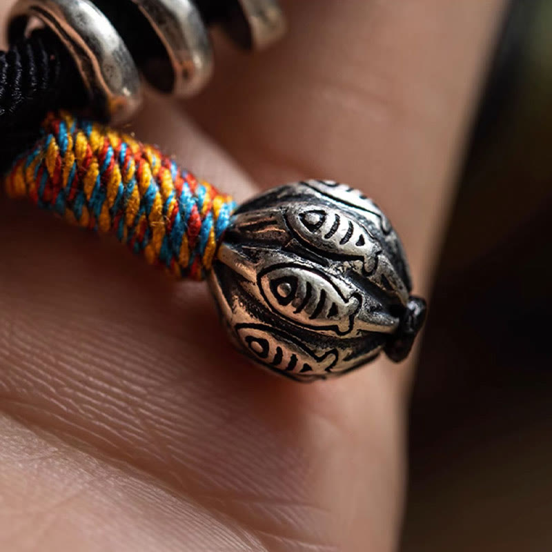 Tibetan Om Mani Padme Hum Wrap Bracelet – S925 silver rings close-up on black cord with S925 stamp detail inset, hand-held macro shot