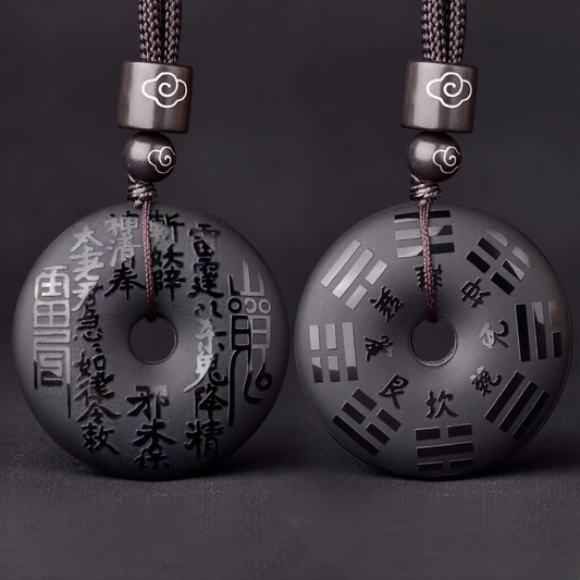 Obsidian Bagua Pendant – pair of black stone discs on dark backdrop, bagua symbols and engraved text