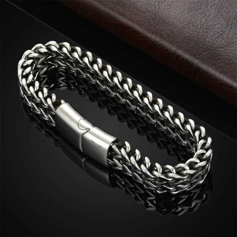 Fish Scale Titanium Steel Magnetic Bracelet – silver double chain on black reflective surface, leather prop, elevated three-quarter