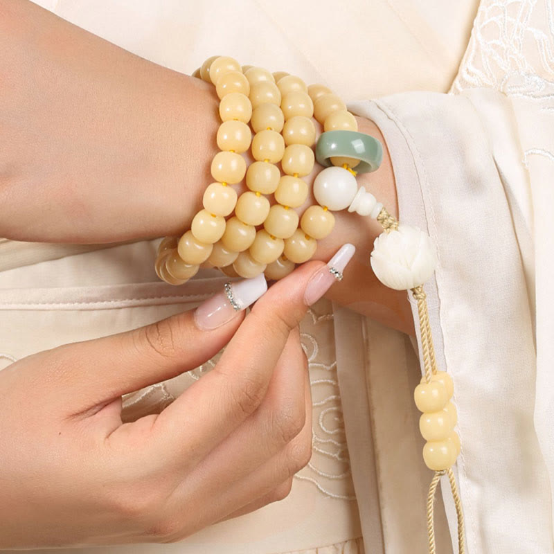 Bodhi Seed Lotus Dzi Bracelet - Multi-wrap bracelet on wrist with carved lotus pendant, bodhi seed