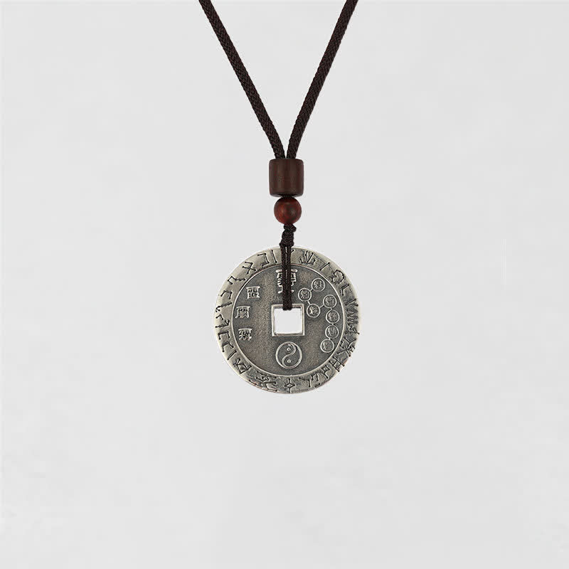 Bagua Yin Yang Obsidian Necklace - engraved silver coin with yin-yang symbols, dark cord front view