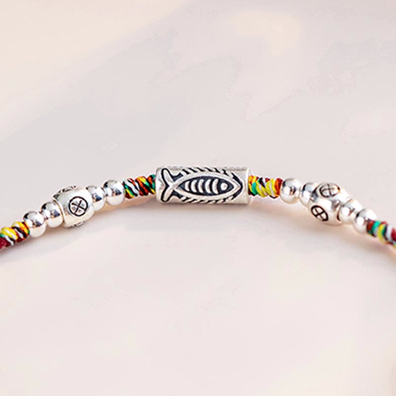 925 Koi Braided Bracelet - angled view of multi-color braided strings with koi silver pendant