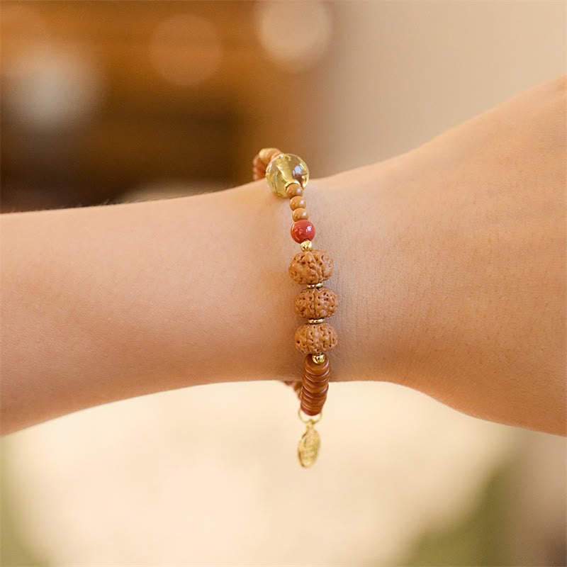Bodhi Seed Bracelet – Dangling charm with stacked disc beads on wrist, meditation beads
