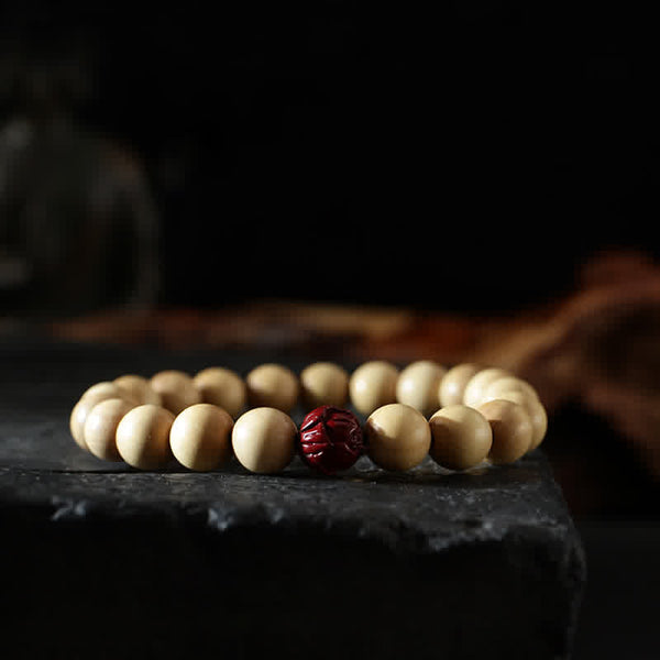 Peach Wood Yin Yang Bracelet – Cinnabar lotus accent bead on cream wooden bracelet, luck charm