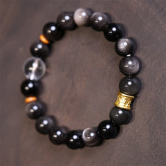 Silver Sheen Obsidian Mantra Bracelet – close-up of mixed obsidian and quartz beads with gold charm, spiritual jewelry