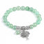 Tree of Life green aventurine bracelet with pale green gemstone beads, silver tree pendant with branches and roots, silver floral spacers.