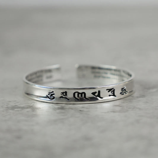 Tibetan Mantra Copper Bracelet - Side view of polished open cuff with engraved mantra, Tibetan bracelet