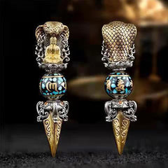 Tibetan Vajra Rotating Pendant – Two ornate silver phurba daggers with turquoise enamel beads and seated Buddha figures side by side, dark atmospheric bokeh, frontal
