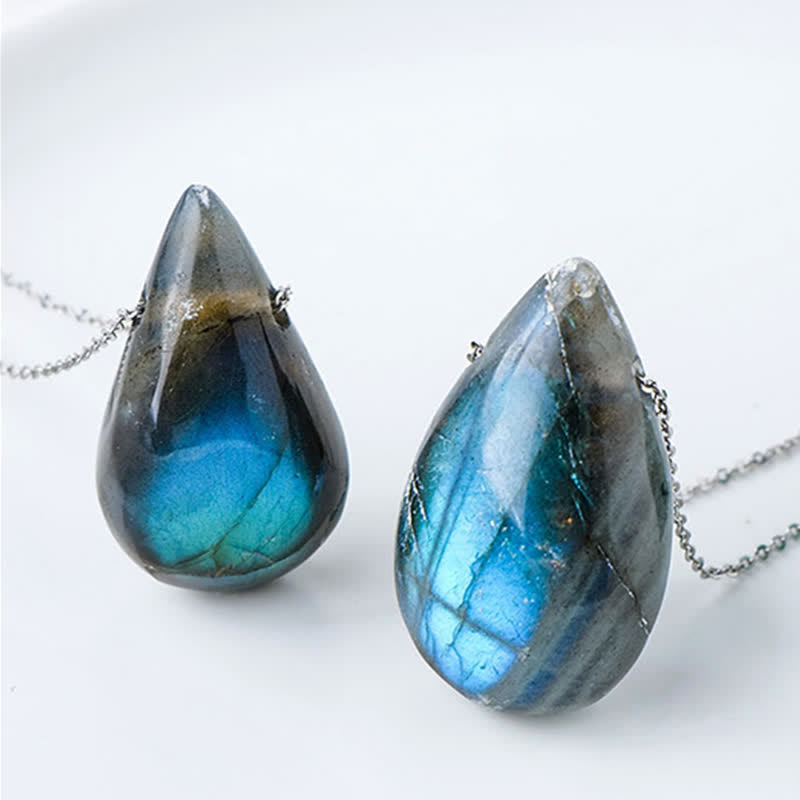 Labradorite water drop pendant necklaces showing two polished pear-shaped labradorite cabochons with electric blue and teal labradorescence on silver chains against clean white background